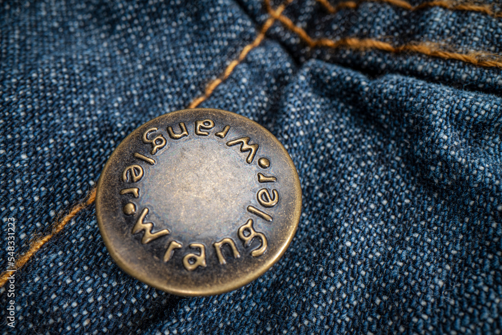 Fort Collins, CO, USA - November 14, 2022: Closeup of Wrangler metal button  on a trucker denim jacket. Wrangler is American manufacturer of jeans and  other clothing. Stock Photo | Adobe Stock