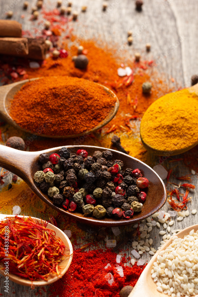 Variety of spices in spoon at table background. Cooking concept and ingredients on kitchen Variety of spices in spoon at table background. Cooking concept and ingredients on kitchen