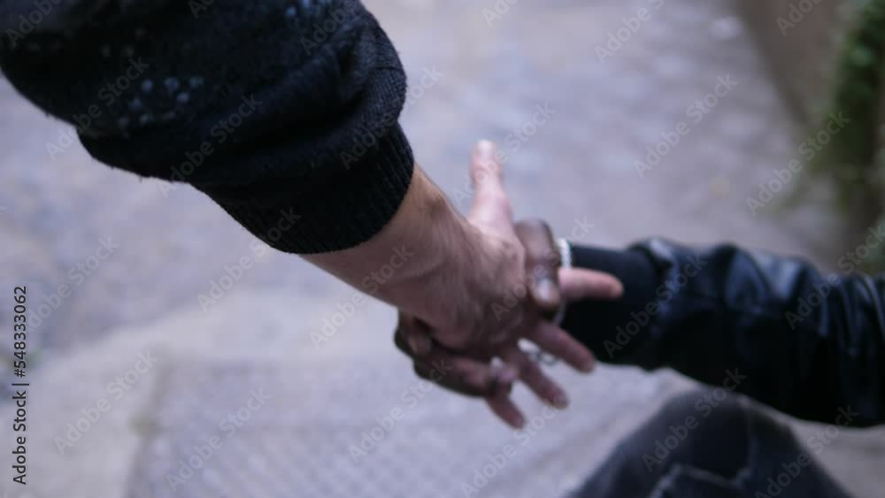 Passing by caucasian man offering helping hand to street man. kindness concept