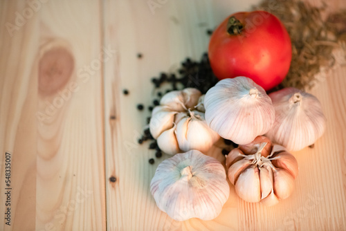 tomatoes garlic onion black paper on wooden board