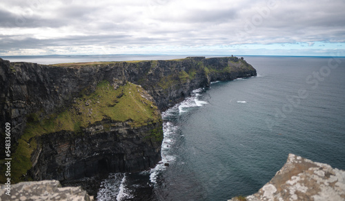 Spectacular view of famous Cliffs of Moher and wild Atlantic Ocean, cloudy day, County Clare, Ireland.