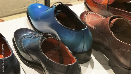 Men's classic formal shoes stand in the window of a shoe store photo