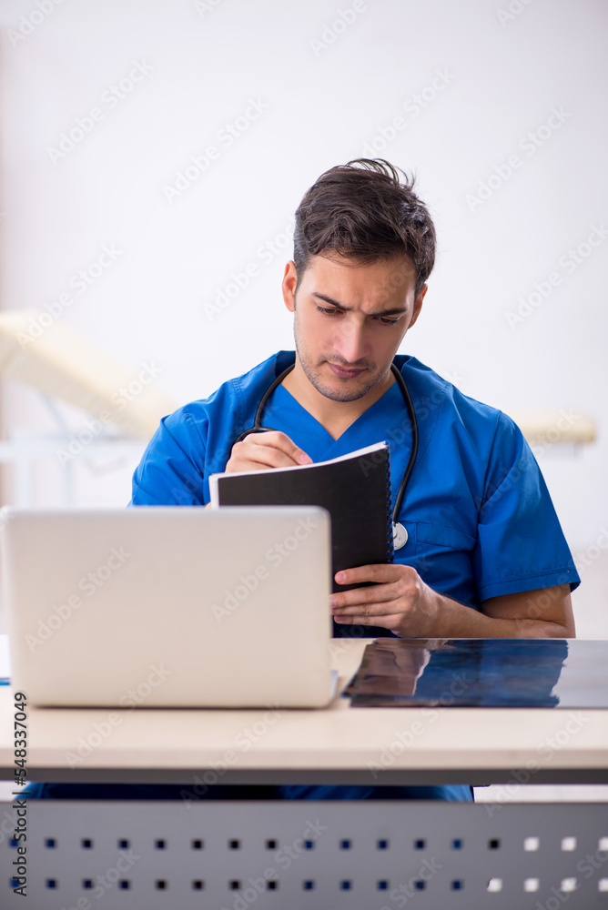 Young male doctor working in the clinic Young male doctor working in the clinic