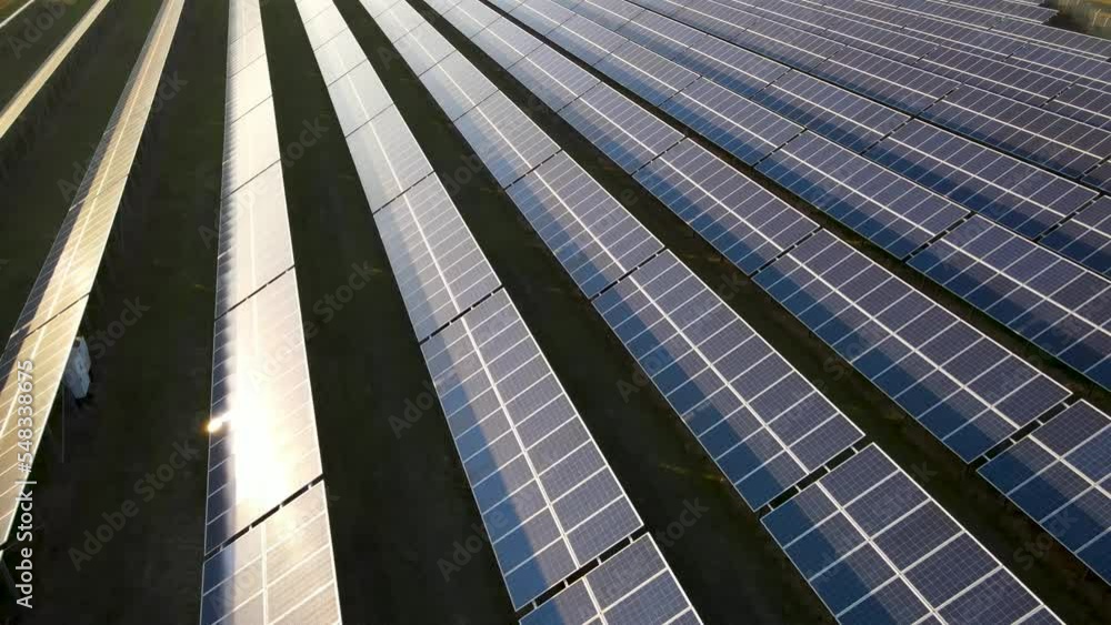 Ecology solar power station blue panels in the fields green energy at sunset landscape electrical innovation. Ecology solar power station blue panels in the fields green energy at sunset landscape electrical innovation.