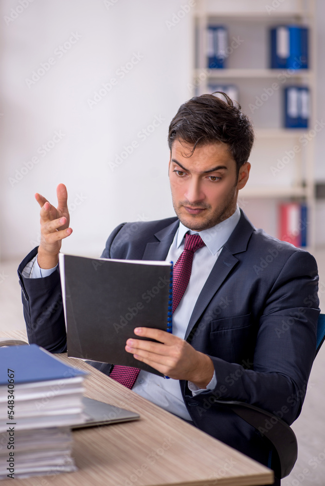 Young male employee working in the office Young male employee working in the office