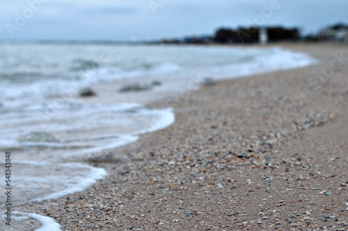 Wallpaper Mural Sea wave rolls along the shore of a sandy beach, autumn footage of the seascape, blurred background, selective focus Sea of Azov, Russia Torontodigital.ca
