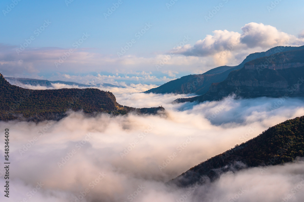 Clouds below the tops of the mountains