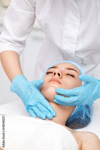 young beautiful woman receiving facial massage. spa