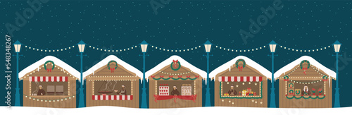 Christmas market wooden stalls kiosks. Market sellers with New Year food, hot drink, mulled wine coffee or tea, sweets and gifts.