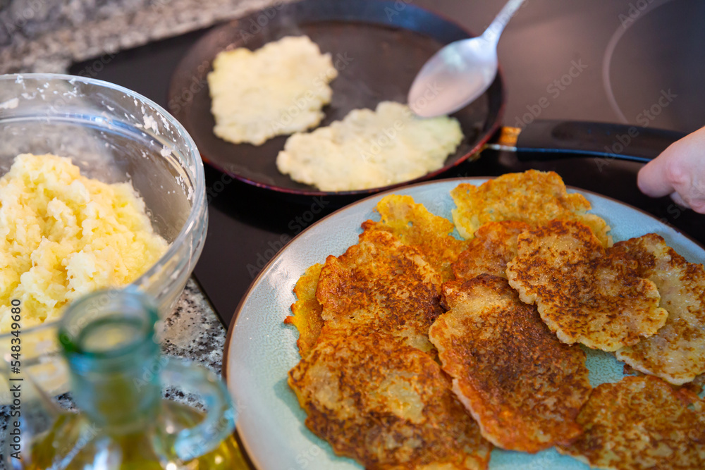 Frying of traditional Belarusian potato pancakes. Closeup of ingredients and fried draniki on plate