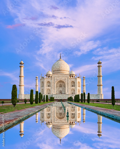 Amazing view on the Taj Mahal in sunset light with reflection in water. The Taj Mahal is an ivory-white marble mausoleum on the south bank of the Yamuna river. Agra, Uttar Pradesh, India.