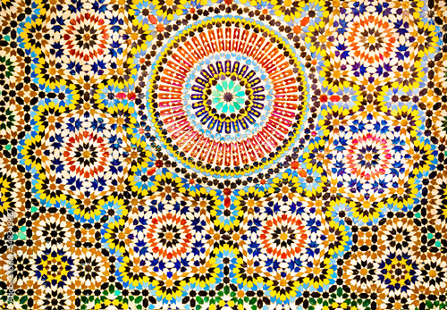 Beautiful Islamic mosaic pattern in Moroccan style. Mosaic oriental ornaments can be found in mosques, important buildings and drinking fountains on the street. Fes, Morocco.