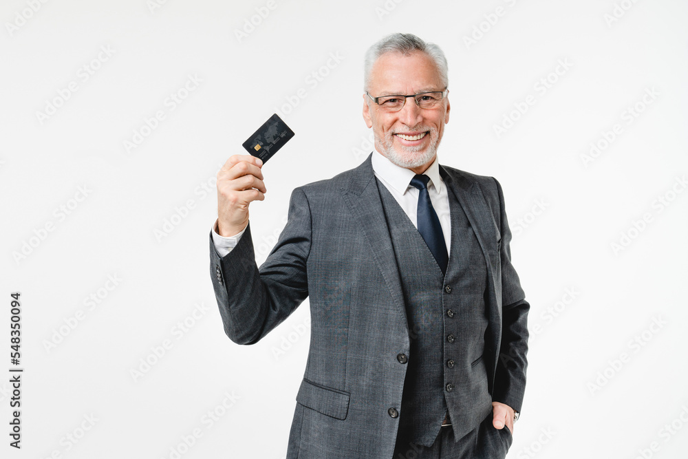 Naklejka premium Successful caucasian mature senior businessman ceo boss professor customer using credit card for e-banking e-commerce, online shopping, loan and cashback isolated in white background