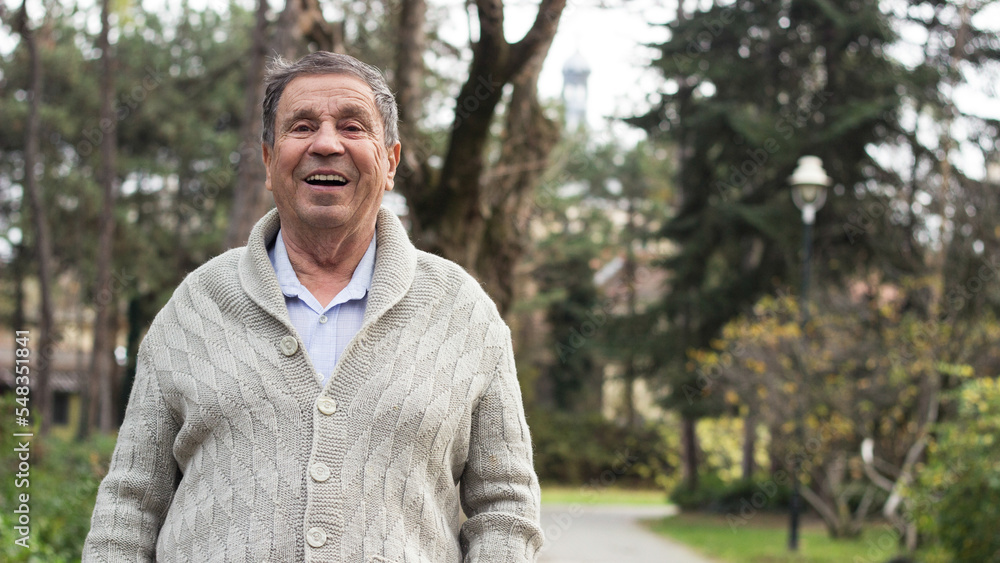 Portrait of a smiling senior man in an autumn park Portrait of a smiling senior man in an autumn park