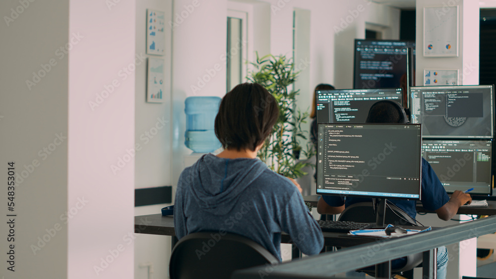 Multiethnic group of programers working on server code to develop new ...