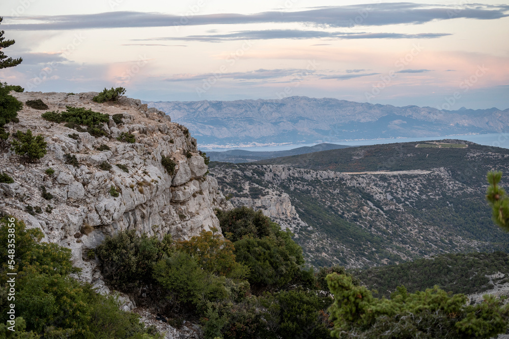 Wonderful landscape of Brac island from Vidova Gora mountain with view on distant Biokovo mountain on croatian mainland, across the sea Wonderful landscape of Brac island from Vidova Gora mountain with view on distant Biokovo mountain on croatian mainland, across the sea