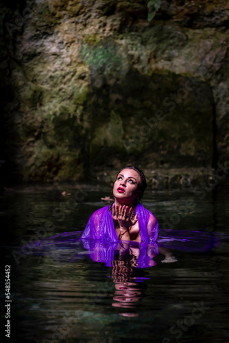 Fototapeta Naklejka Na Ścianę i Meble -  A Lovely Nude Latin Model Enjoys The Beautiful Waters In The Cenotes Near Cuzama, Yucatan, Mexico
