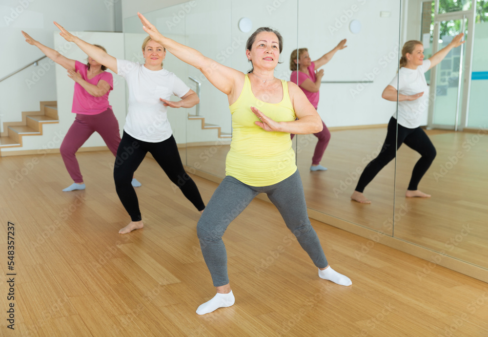 Happy adults training swing steps at dance class