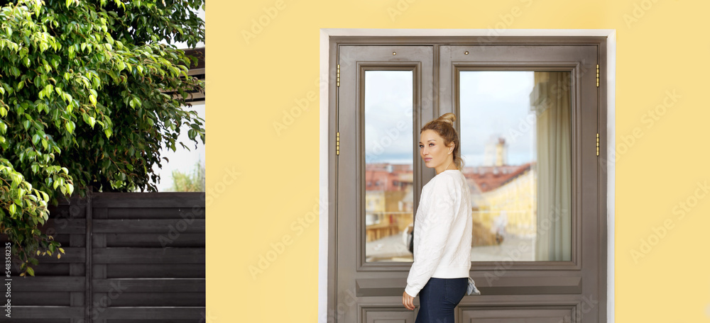 Beautiful woman opening the door of her home.