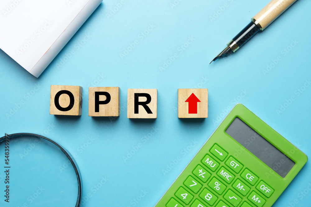 Flatlay picture of wooden block written OPR increase, calculator, magnifying glass, pen and notepad. Flatlay picture of wooden block written OPR increase, calculator, magnifying glass, pen and notepad.