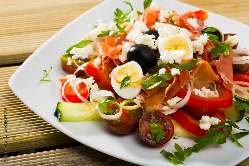 Shepherd salad - traditional Bulgarian dish. Consist of cucumbers, tomatoes, brynza (salted goat cheese) and prosciutto