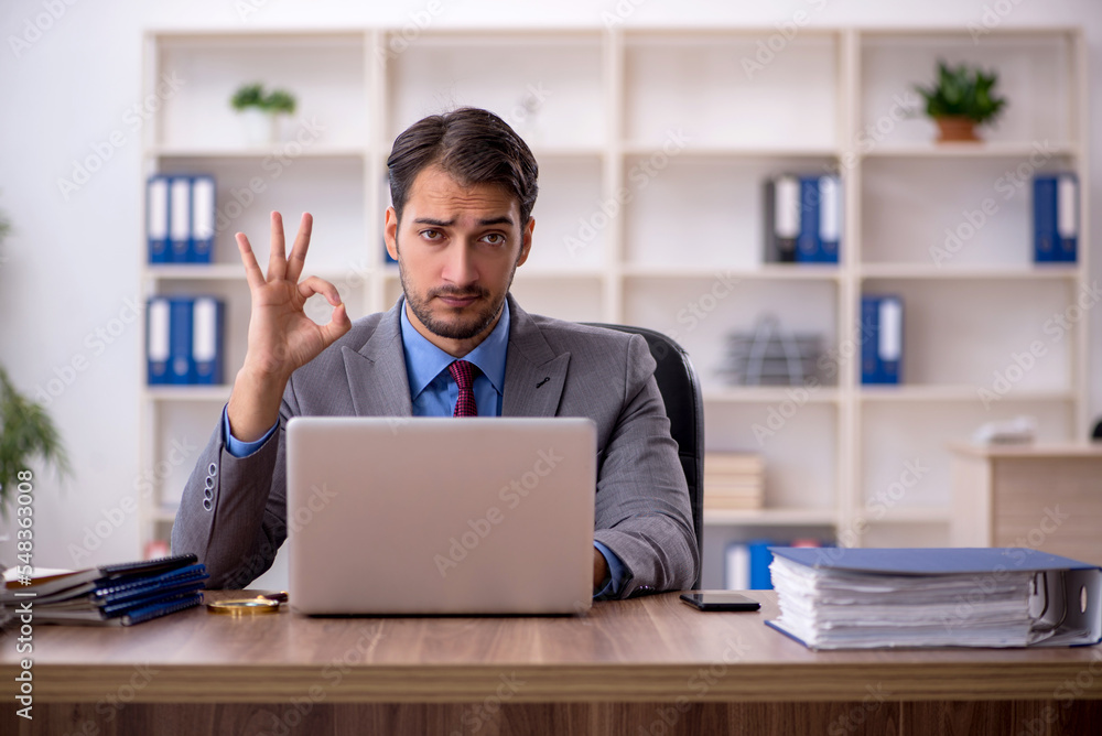 Young male employee working in the office Young male employee working in the office