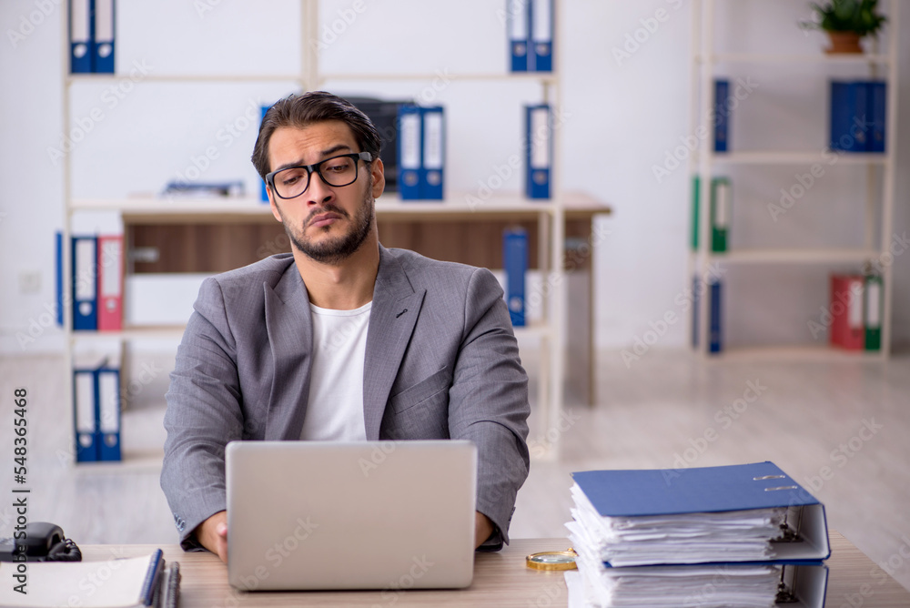 Young male employee working in the office Young male employee working in the office