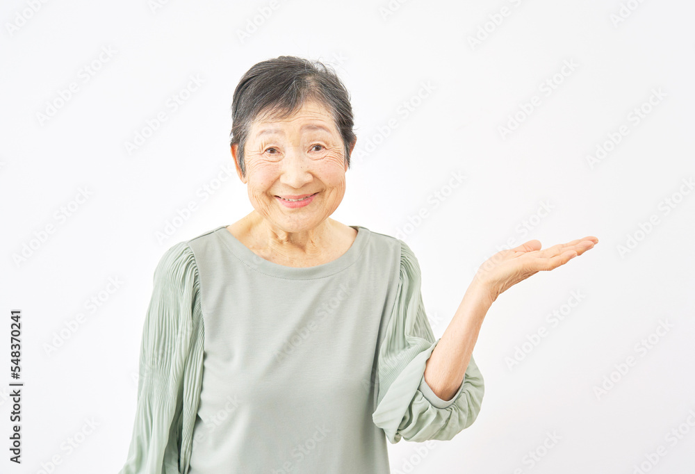 右を手のひらで指す高齢者女性 白背景 右を手のひらで指す高齢者女性 白背景