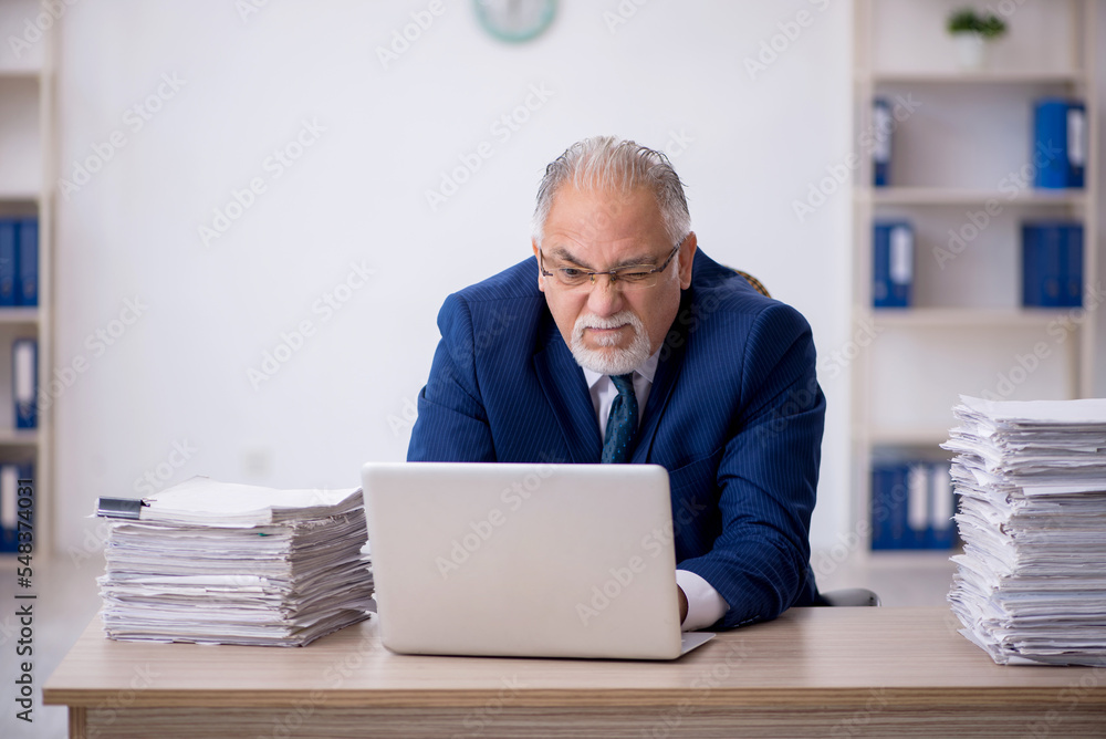 Old male employee and too much work in the office Old male employee and too much work in the office