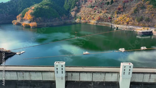 water dam and reservoir lake in the mountains, aerial view of hydropower electric power plant for renewable energy, sustainable hydroelectricity, water resources photo
