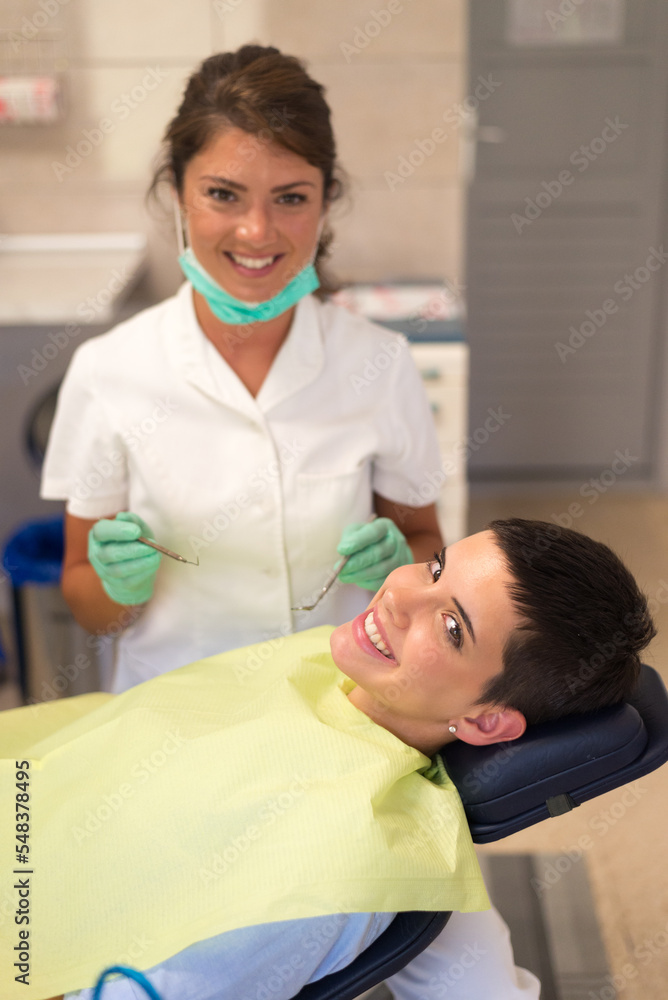 Young woman checking her teeth at the dentist clinic Young woman checking her teeth at the dentist clinic
