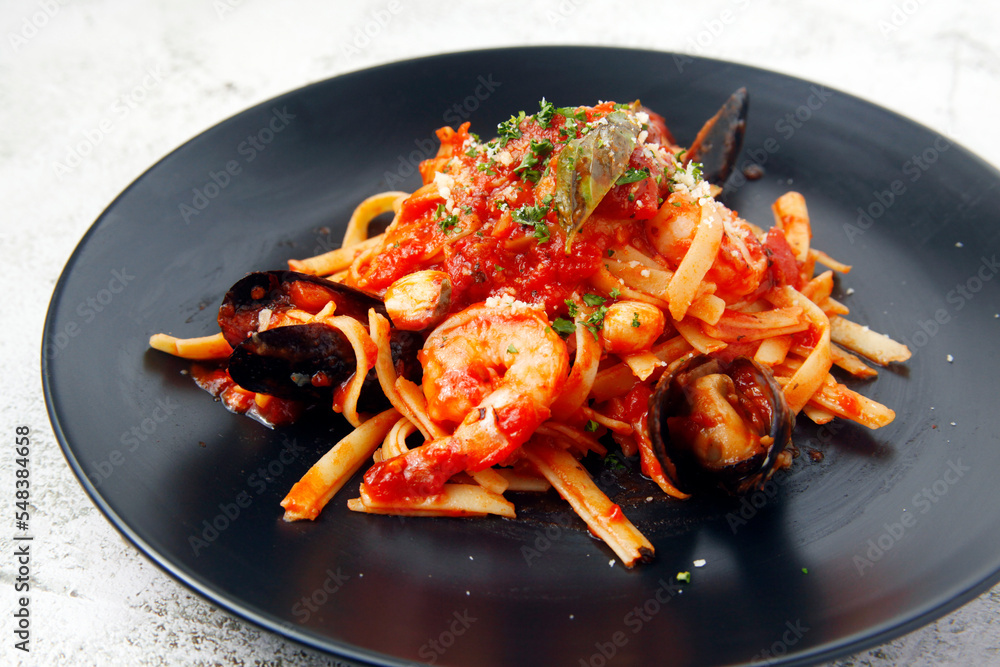 Freshly cooked seafood pasta in marinara sauce Freshly cooked seafood pasta in marinara sauce