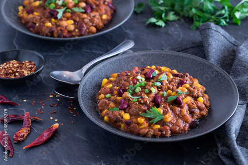 Bowls of delicious black bean and corn chili con carne  ready for eating.