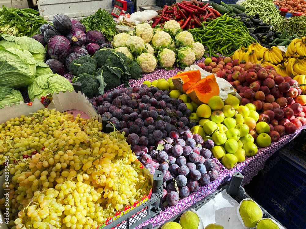 Sunny market. fruits and vegetables on the traditional market. the crop is sold in boxes. market with various colorful fresh fruits and vegetables