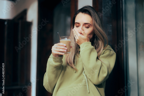 Woman Suffering a Toothache being Sensitive to Hot Drinks. Unhappy young person having a teeth sensitivity to cold or hot temperatures

 photo