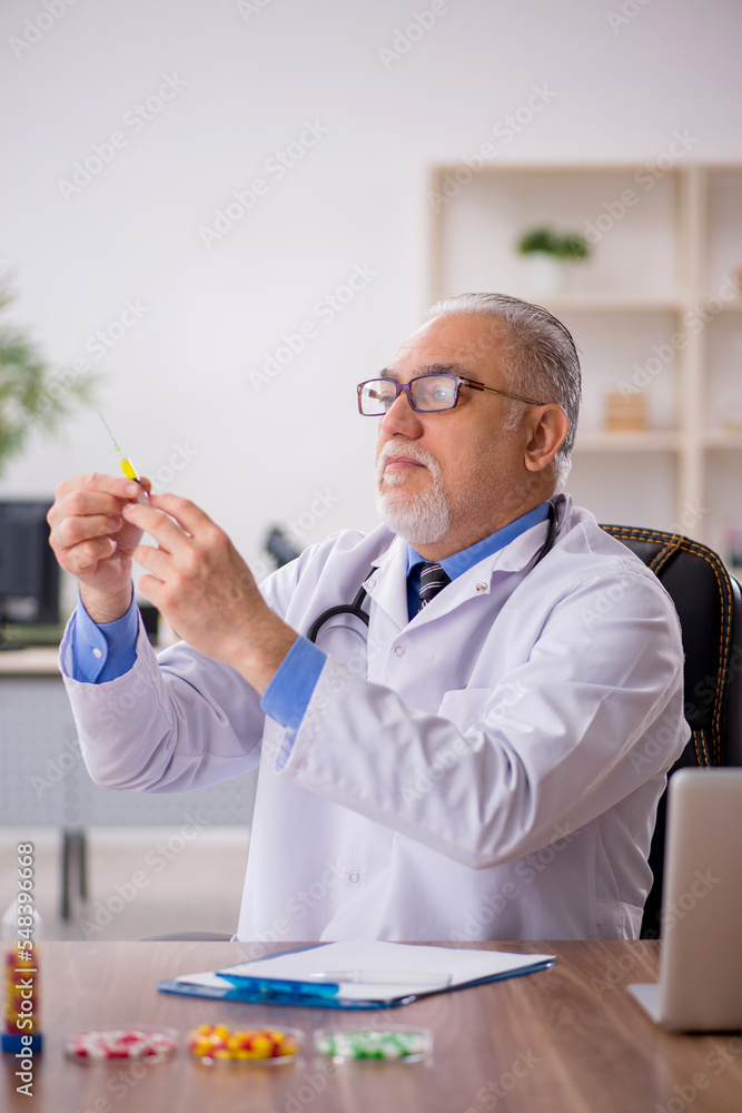 Old male doctor pharmacist in drugs synthesis concept Old male doctor pharmacist in drugs synthesis concept
