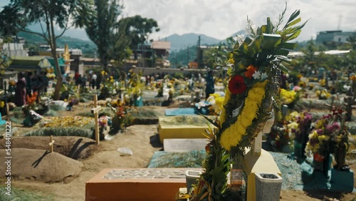 Beautiful Marigold Flower Arrangement Over Headstone On The Graveyards In Sumpango, Guatemala. Rotating Shot photo