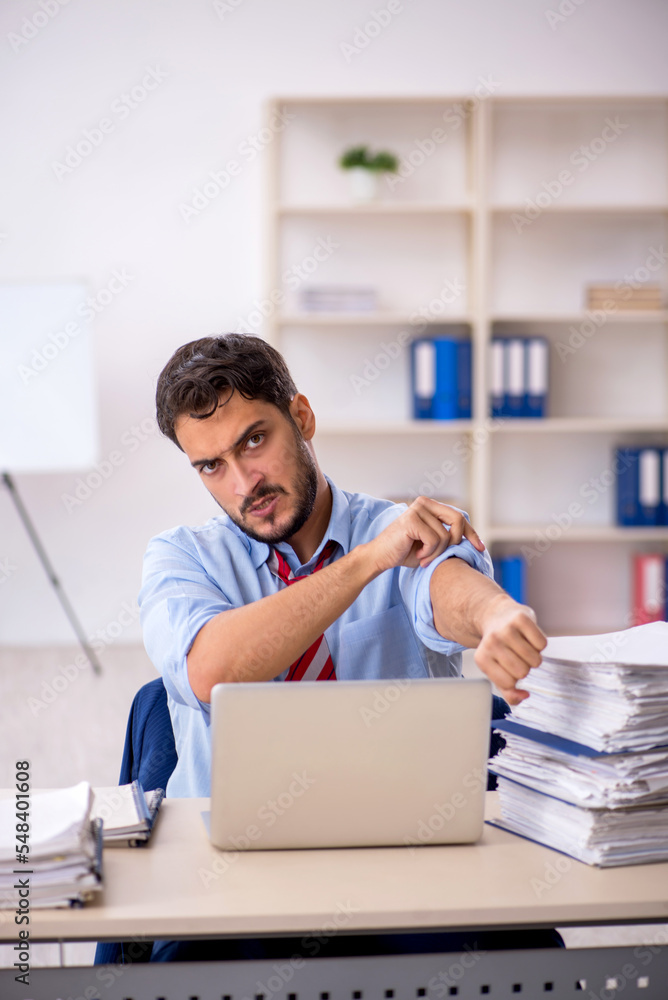Young male employee working in the office Young male employee working in the office