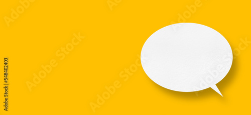 White paper in speech bubble shape set against yellow background.