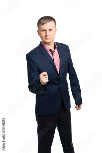 a young man in a business suit shows a fig, with a gesture demonstrates that you will not get anything. isolated