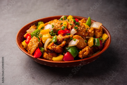 Chilli chicken which is a popular Indo-Chinese starter dish, served on a plate or bowl. Selective focus