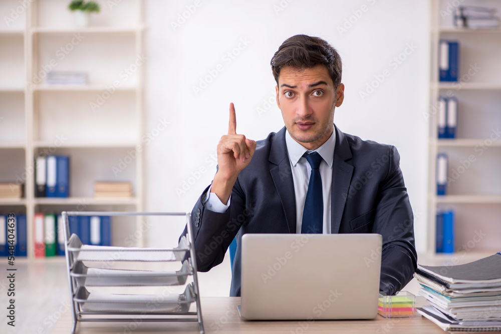 Young male employee working in the office Young male employee working in the office
