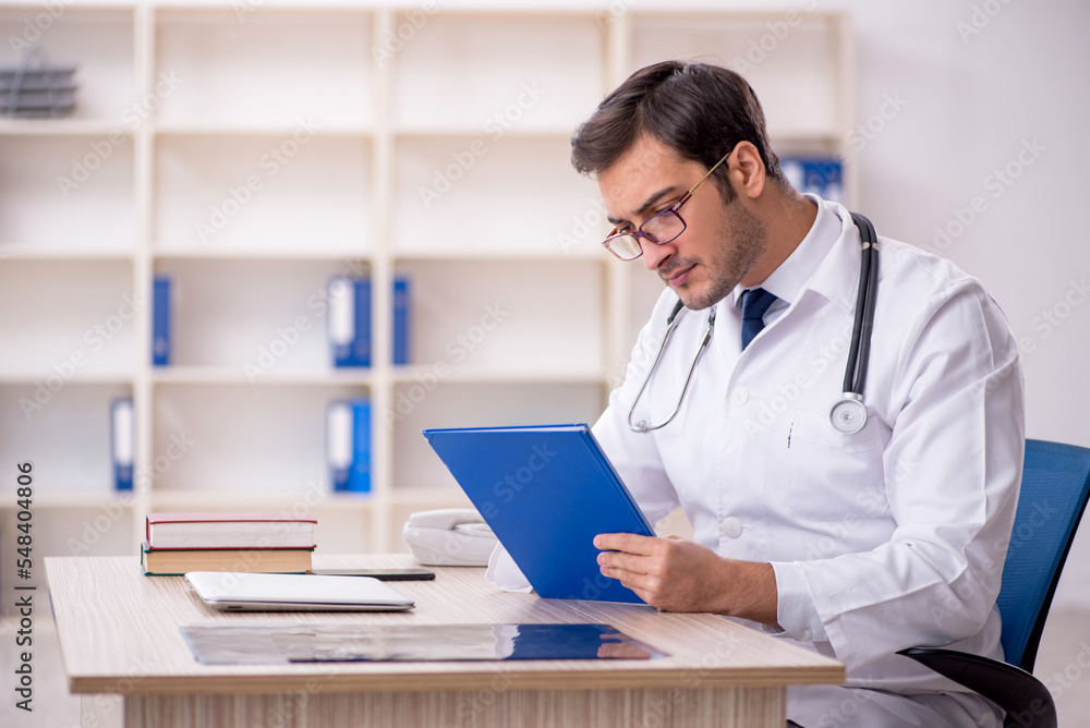 Young male doctor working in the clinic Young male doctor working in the clinic