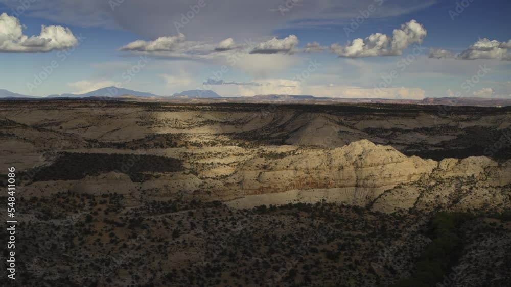 Aerial flyover view of clouds over sandstone rock formations / Boulder, Utah, United States Aerial flyover view of clouds over sandstone rock formations / Boulder, Utah, United States