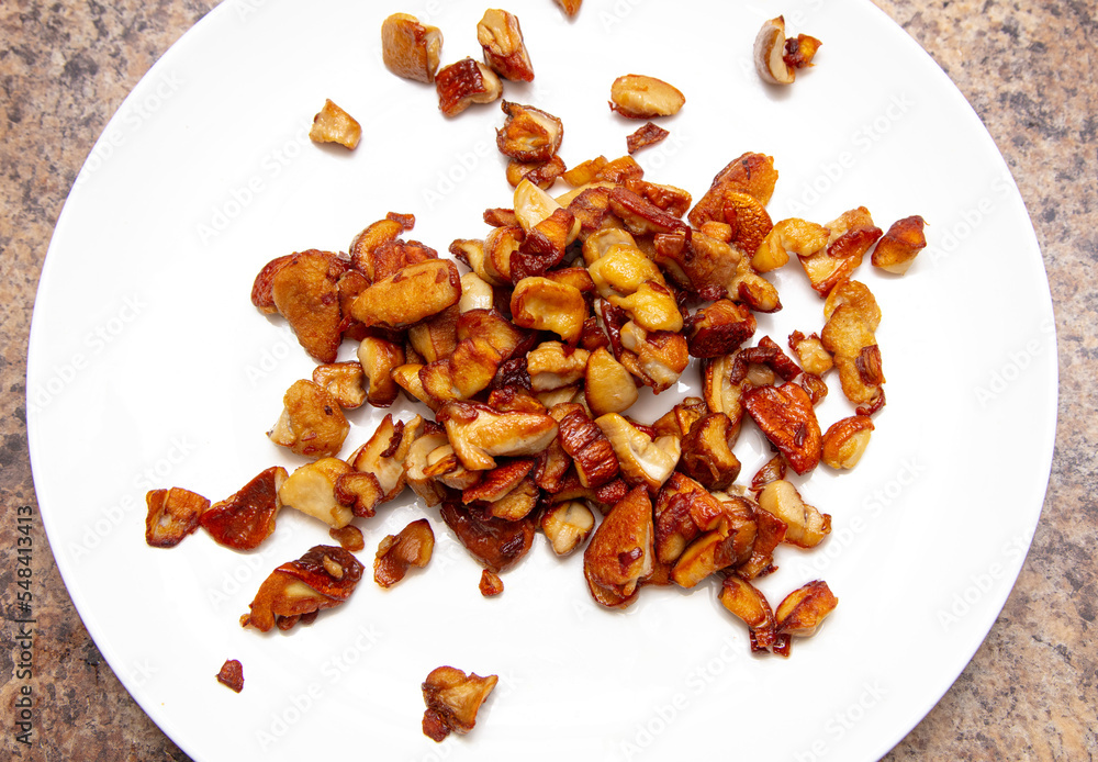 Fried mushrooms in a white plate on the table. Fried mushrooms in a white plate on the table.