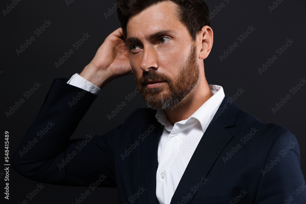 Portrait of handsome bearded man looking away on black background Portrait of handsome bearded man looking away on black background