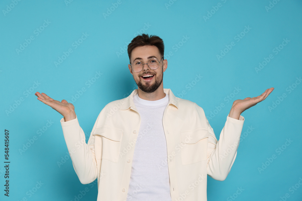 Surprised man in white jacket and eyeglasses on light blue background Surprised man in white jacket and eyeglasses on light blue background