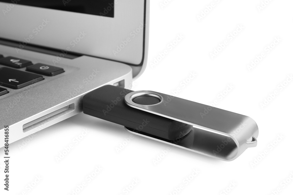 Modern usb flash drive attached into laptop on white background, closeup Modern usb flash drive attached into laptop on white background, closeup