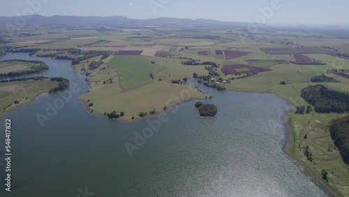 Green Lakeside Meadows On Lake Tinaroo Near Yungaburra Town In North Queensland, Australia. aerial photo