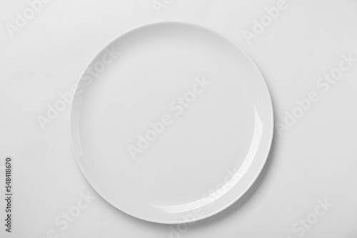 Empty ceramic plate on white background, top view